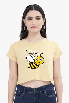 A stylish woman crop top in a vibrant yellow hue, featuring a playful ‘Bee kind’ graphic