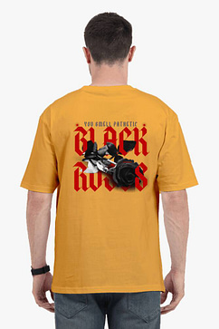 A man showcasing the back of a yellow oversize t shirt with a bold red and black graphic