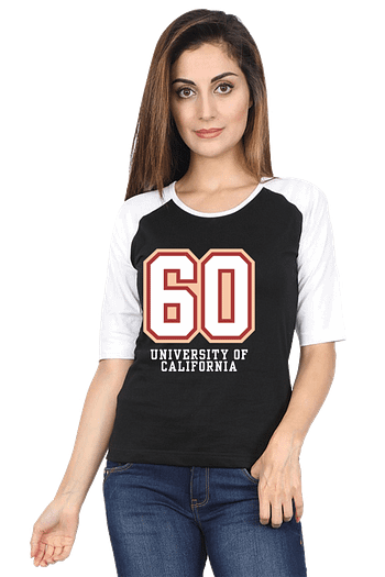 A woman with long hair is wearing a black and white raglan t-shirt featuring the number 60 and the words University of California. She is also wearing blue jeans and standing against a plain background.