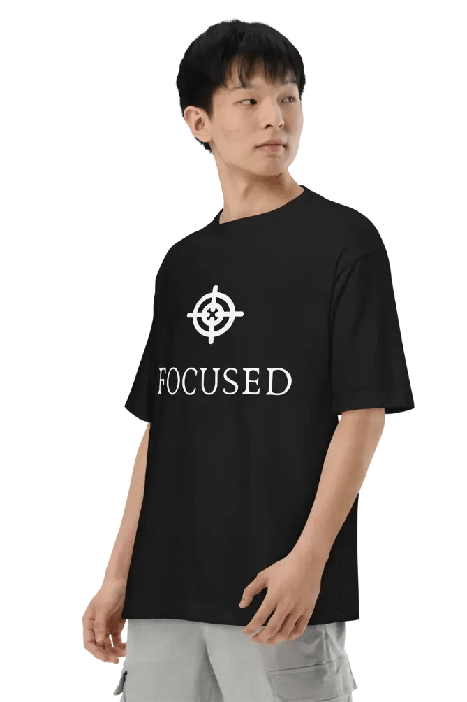 Trendy black t-shirt with ‘FOCUSED’ logo and text design modeled by a stylish individual.