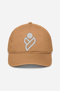 A unisex baseball cap in a versatile tan color, featuring a white logo emblem on the crown, suitable for both men and women