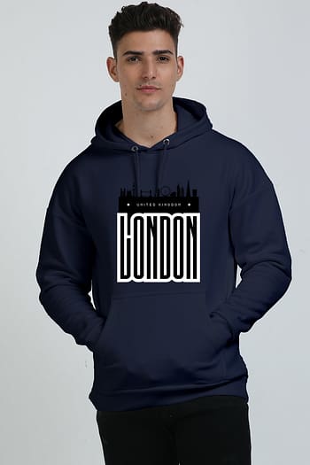 A person wearing a heavyweight navy blue hooded sweatshirt featuring the London skyline and LONDON in bold, white capital letters on the front against a plain white background.